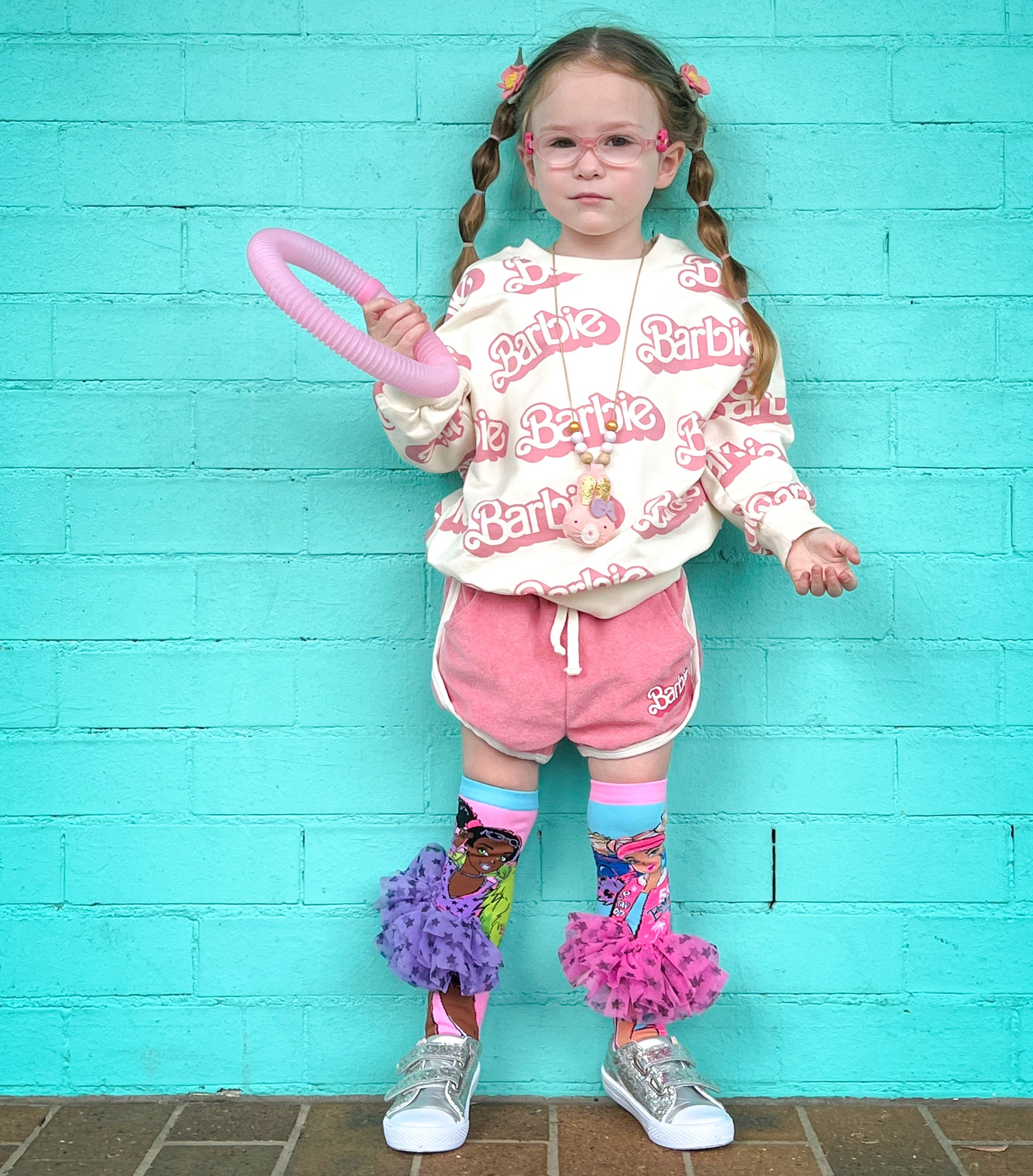 Colorful Barbie knee high socks with playful fashion-inspired graphics and tutu details.
