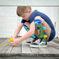 Colorful dinosaur socks featuring fun dino graphics and soft plush spike details.