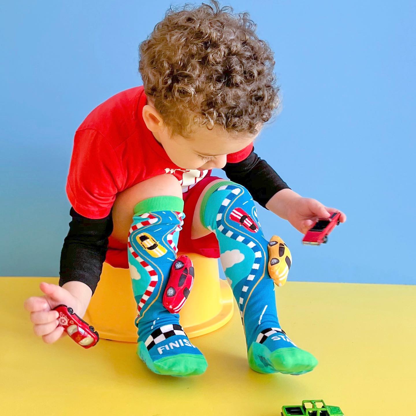 Colorful racing car socks featuring playful race graphics and bright sporty design.