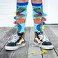 Fun dinosaur knee high socks featuring bright colors and playful plush spike details.