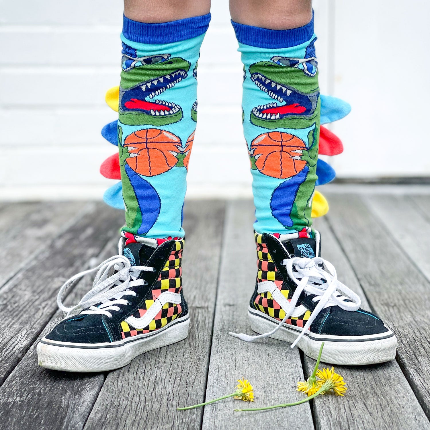 Fun dinosaur knee high socks featuring bright colors and playful plush spike details.