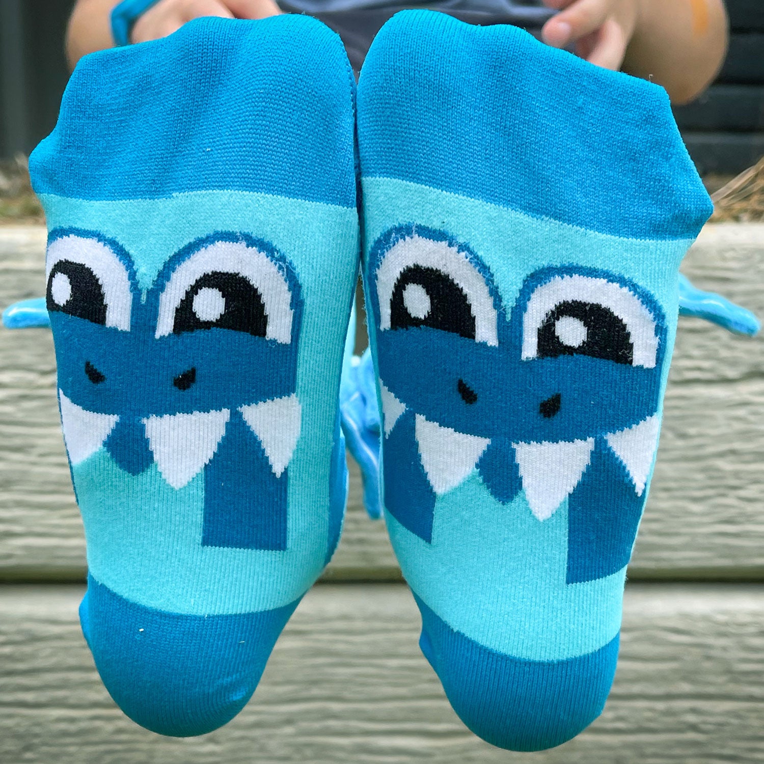 Fun shark knee high socks with colorful sea-inspired graphics and playful plush fins.