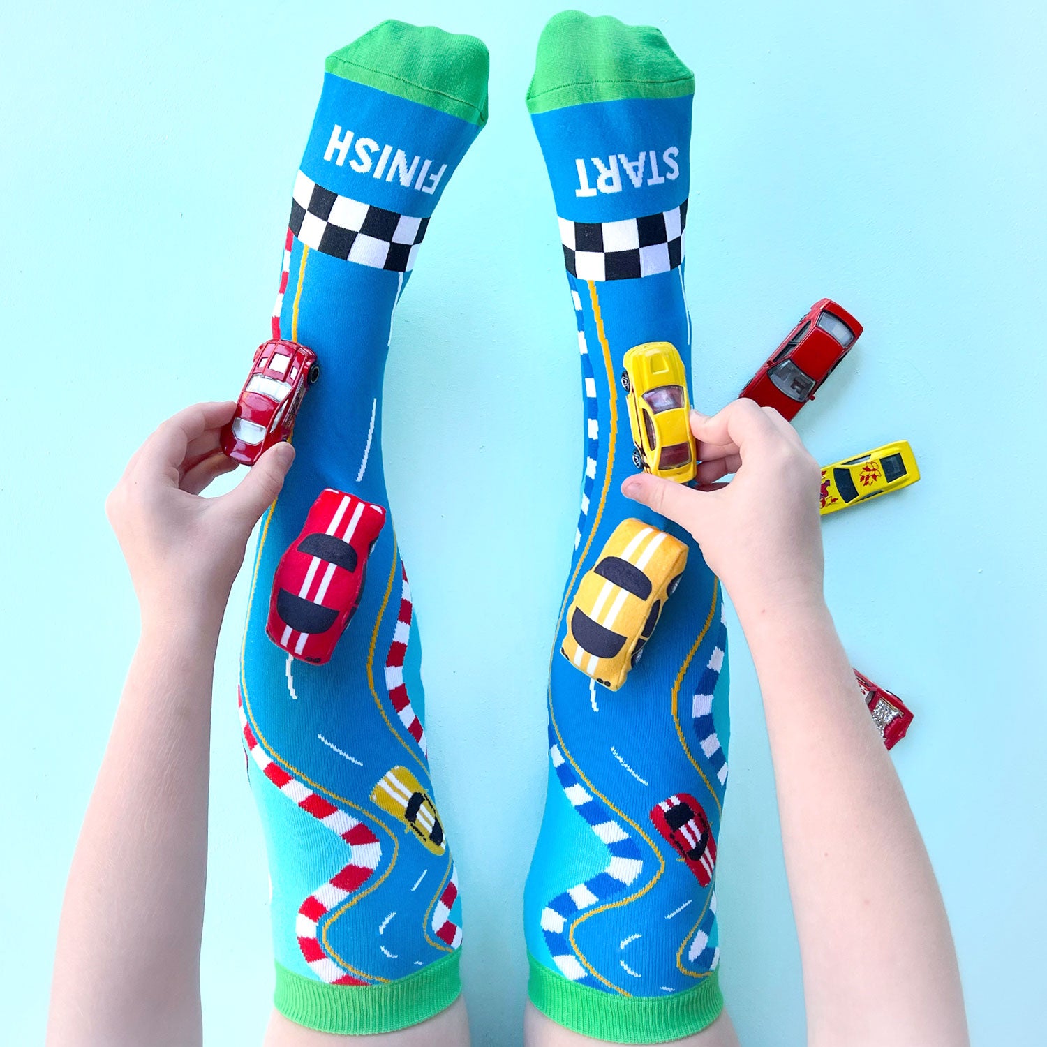 Race track style novelty socks with colorful car graphics and sporty playful design.